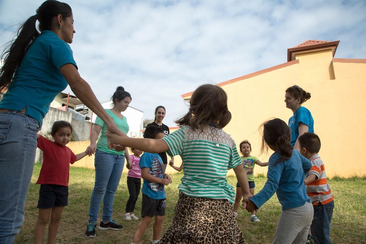 The children play games during recess with a Projects Abroad volunteer teaching in Costa Rica A volunteer gaining her teaching work experience in Costa Rica plays outside with her students